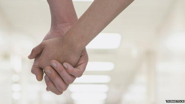 holding hands in hospital