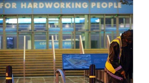 A cleaner sweeps the steps outside the venue of the 2013 Conservative conference