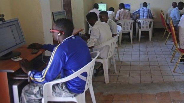 People use computers at an internet cafe in the Hodan area of Mogadishu, 9 October 2013