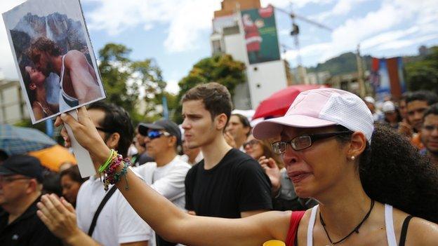 demonstrators and woman crying