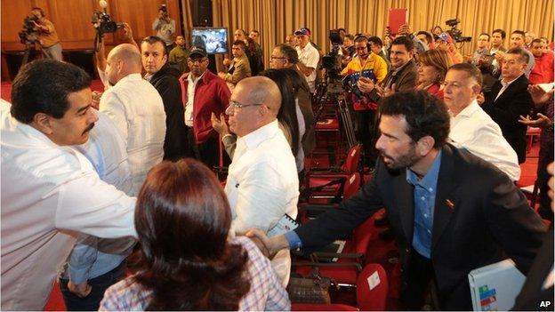 President Maduro shaking hands with Henrique Capriles