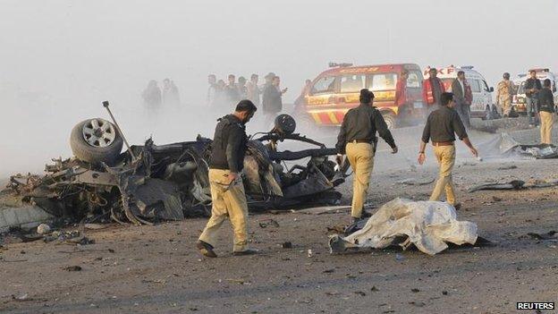 Pakistani police at the scene in Karachi, 9 Jan