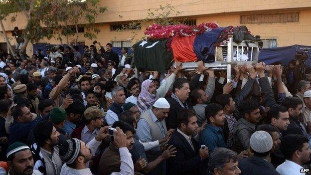 Pakistani government officials and comrades carry the coffin of police officer Chaudhry Aslam during his funeral in Karachi on January 10, 2014.