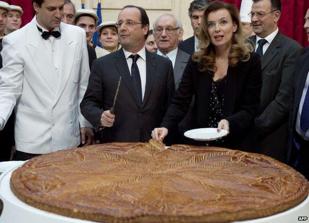 French President Francois Hollande and Valerie Trierweiler attend an epiphany cake-cutting at the Elysee Palace in Paris, 7 January