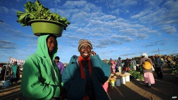 Zimbabwean women shop for vegetables in Jambanja market in Seke, south of Harare, on 2 August 2013