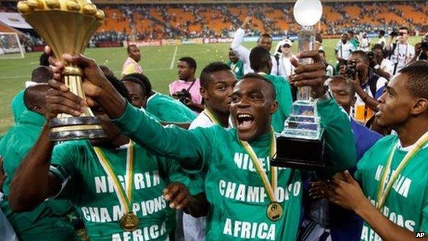 Nigeria's Emmanuel Emenike holds the trophy after they defeated Burkina Faso in the final to win the African Cup of Nations at the Soccer City Stadium in Johannesburg, South Africa, on 10 February 2013