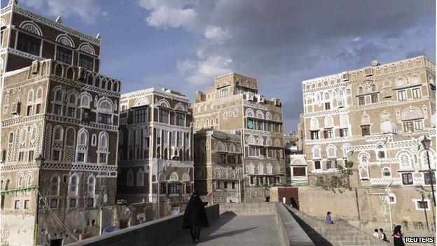 A woman walks on a bridge in the Old Sanaa city, Yemen (January 10, 2014)