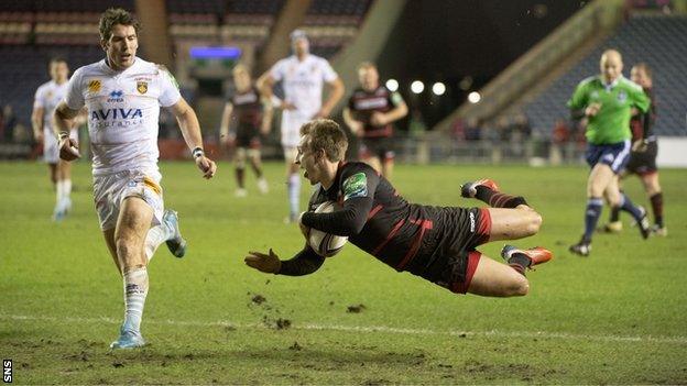 Tom Brown flies over the line to complete his try for Edinburgh.