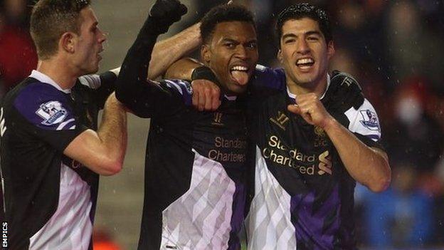 Liverpool's Luis Suarez celebrates scoring his side's fourth goal with Daniel Sturridge (centre)