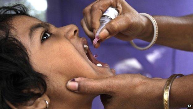 A child in India receives oral polio vaccine