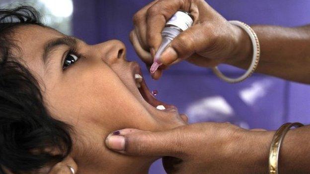 A child in India receives oral polio vaccine