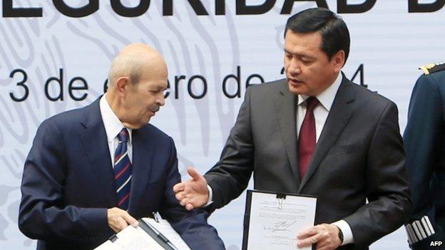 Mexican Interior Secretary Miguel Angel Osorio Chong (right) extends his hand to Michoacan state Governor Fausto Vallejo