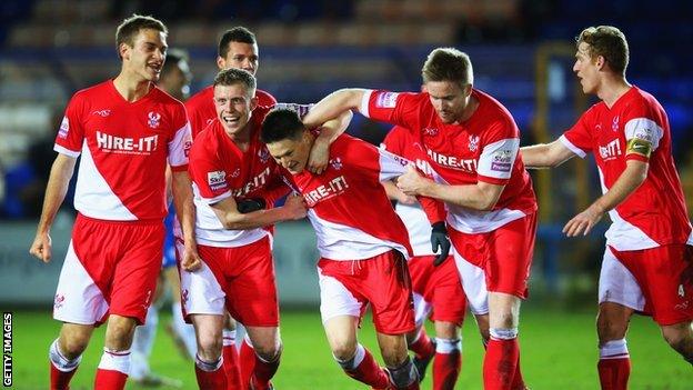 Joe Lolley celebrates Kidderminster's winner at Peterborough with team-mates.