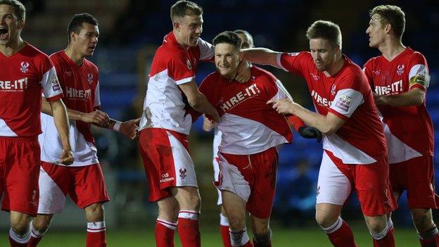 Harriers players celebrate Joe Lolley's matchwinning goal at London Road