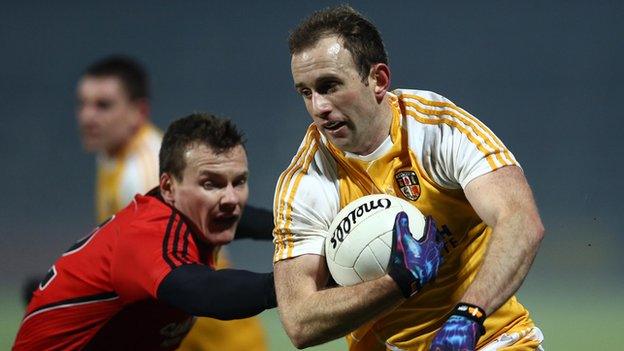 Antrim's Michael Pollock attempt to burst away from Down's Dan McCartan