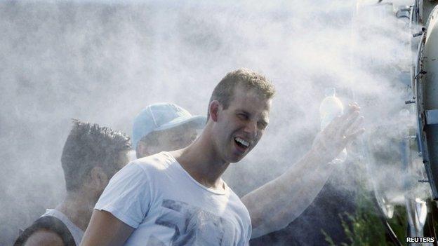 Spectators cool off in front of a misting fan at the Australian Open 2014 tennis tournament in Melbourne 16 January 2014