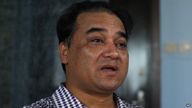 Outspoken Uighur scholar and advocate Ilham Tohti speaks during an interview at his home in Beijing on 5 July 2013