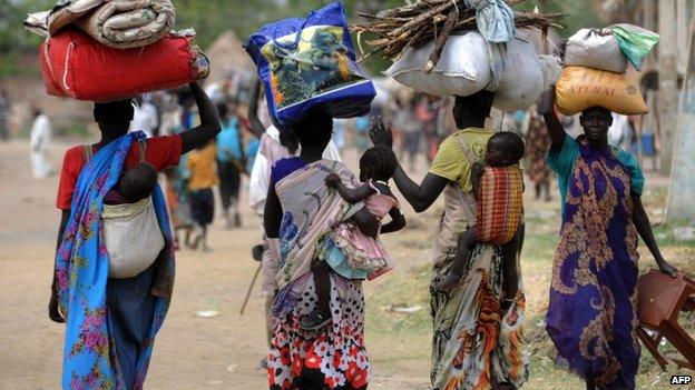 Displaced South Sudanese women walk towards the United Nations mission base in Malakal, South Sudan - 13 January 2014