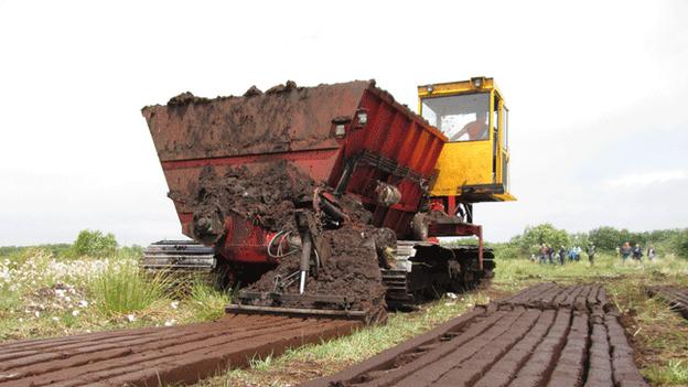 A turf-cutting machine on Monivea Bog, Co Galway, Republic of Ireland, July 2013