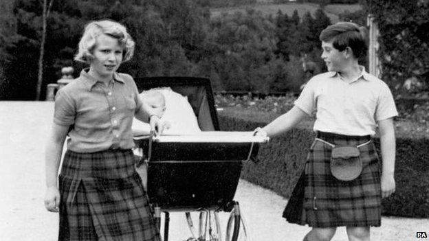 Princess Anne and Prince Charle pulling the pram of baby brother Prince Andrew at Balmoral in 1960