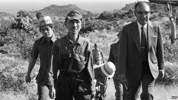 File photo: former Japanese imperial army soldier Hiroo Onoda (second left) walking from the jungle where he had hidden since World War II, on Lubang island in the Philippines, 11 March 1974