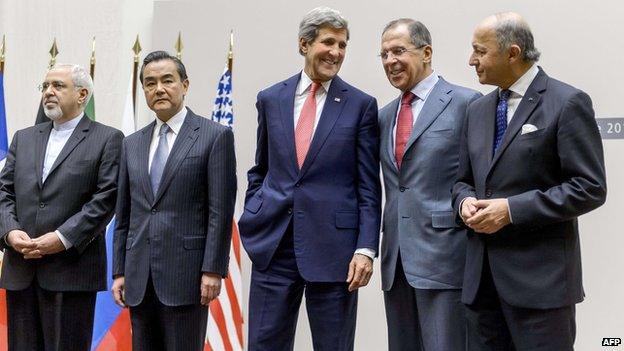 Iranian Foreign Minister Mohammad Javad Zarif, Chinese Foreign Minister Wang Yi, US Secretary of State John Kerry, Russian Foreign Minister Sergei Lavrov and French Foreign Minister Laurent Fabius react during a statement on early November 24, 2013 in Geneva