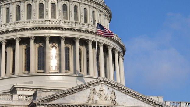 The rising sun glints off of windows in the Capitol in Washington (Sept. 2, 2013)