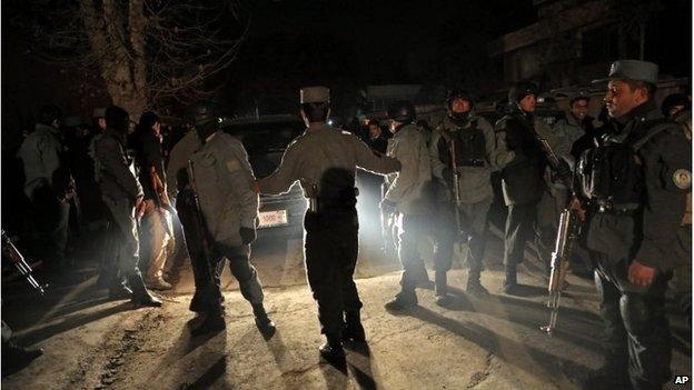 Afghan security forces work at the site of a suicide attack in Kabul, Afghanistan, January 17