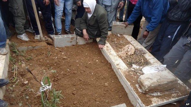 This undated activist photo provided by the group Palestinians of Syria on Monday, Jan. 13, 2014 shows a funeral for a resident who died during the siege of the Palestinian neighbourhood of Yarmouk