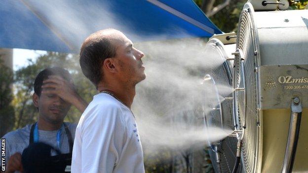 A tennis fan cools off in extreme heat at the Australian Open