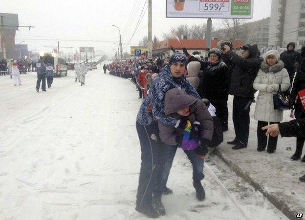 A security guard restrains gay rights protester Pavel Lebedev at the Olympic relay in Voronezh, 18 January