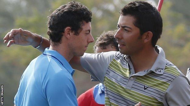 Rory McIlory (L) congratulates Pablo Larrazabal on wining the Abu Dhabi Championship