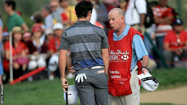 Rory McIlroy in deep conversation with Ricardo Gonzalez's caddy Dave Renwick