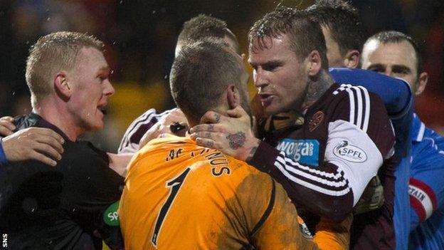 Alan Mannus and Ryan Stevenson clash at McDiarmid Park