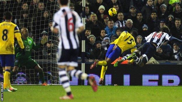 West Brom player Diego Lugano (right) dives to head the first West Brom goal