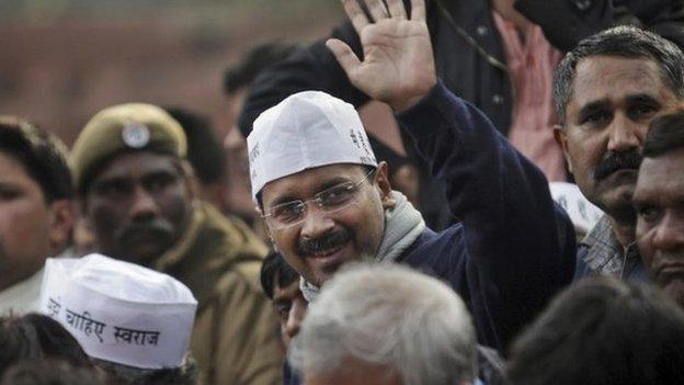 Delhi state Chief Minister Arvind Kejriwal waves to his supporters during a demonstration against the police in Delhi on 20 January 2014