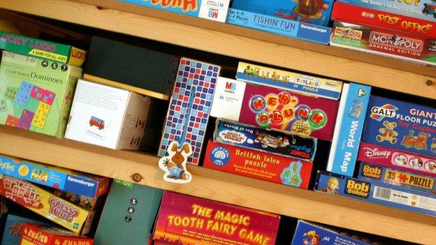 Shelves stocked with board games and toys.