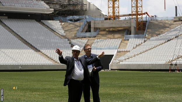 Jerome Valcke (right) speaks with an engineer during a visit to the Arena Corinthians stadium