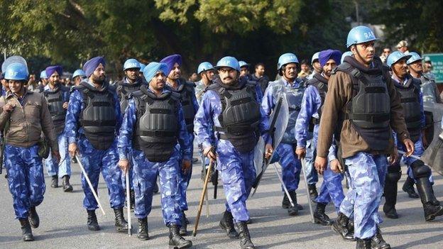 India""s Rapid Action Force (RAF) personnel walk at the site of a protest by Delhi's chief minister Arvind Kejriwal (not pictured) in New Delhi January 20, 2014.