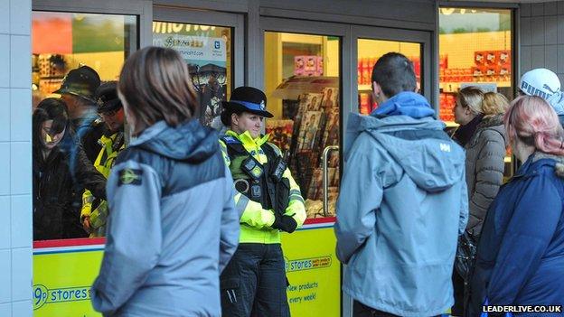 Police officers at the 99p Stores in Wrexham