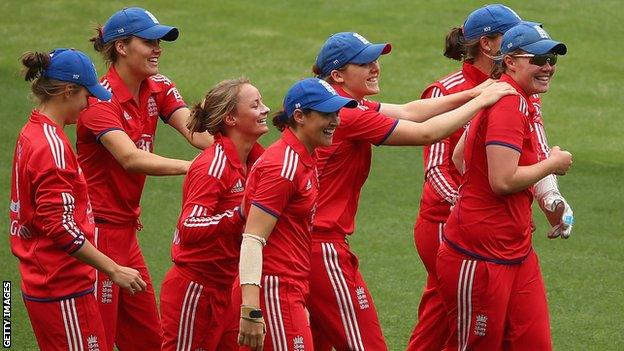 Anya Shrubsole and Danielle Wyatt of England celebrate the wicket of Jessica Cameron of Australia with their teammates.