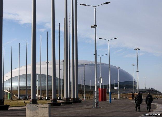 Security guards walk near the Olympic Park in Adler, Russia, 9 January