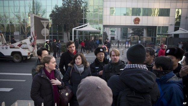 Chinese policemen try to block foreign diplomats talking to journalists as they prepare to attend a trial of Xu Zhiyong outside the Beijing's No. 1 Intermediate People's Court, China, 22 January 2014