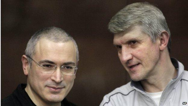 Platon Lebedev (right) and Mikhail Khodorkovsky (left) talk behind a glass enclosure at a courtroom in Moscow, Russia on 30 December 2010.