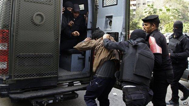 Man detained by police during clashes with pro-Morsi supporters in Nasr City, Cairo, on 17 January 2014