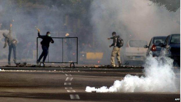 Egyptian protesters and supporters of the Muslim Brotherhood are seen during clashes with Egyptian police in the northern port city of Alexandria on 23 January 2014.