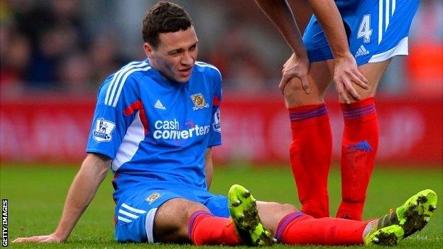 James Chester of Hull City sits on the pitch injured