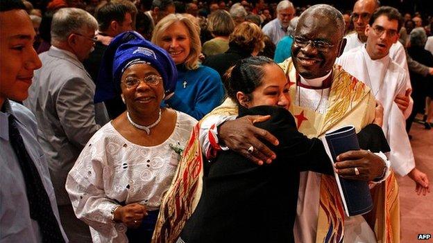 Nigeria's Peter Akinola (R) is embraced by congregants at a chapel in the US on 5 May 2007