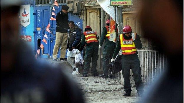 Pakistani volunteers search the site of a suicide bomb attack in Rawalpindi on January 20, 2014. A Taliban suicide bomber killed at least nine people in a market close to Pakistan's military headquarters, a day after one of the deadliest attacks on security forces in recent years.