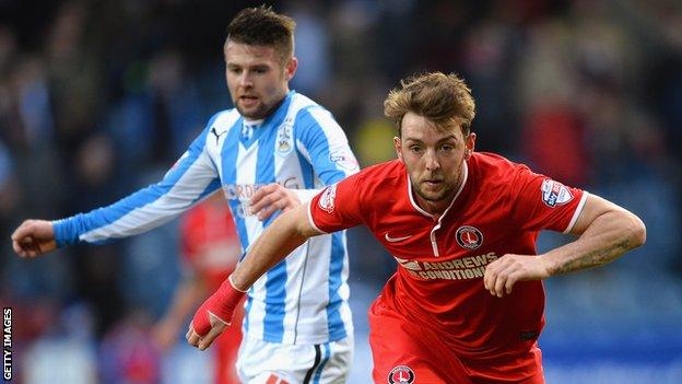 Oliver Norwood of Huddersfield challenges Charlton's Johnnie Jackson